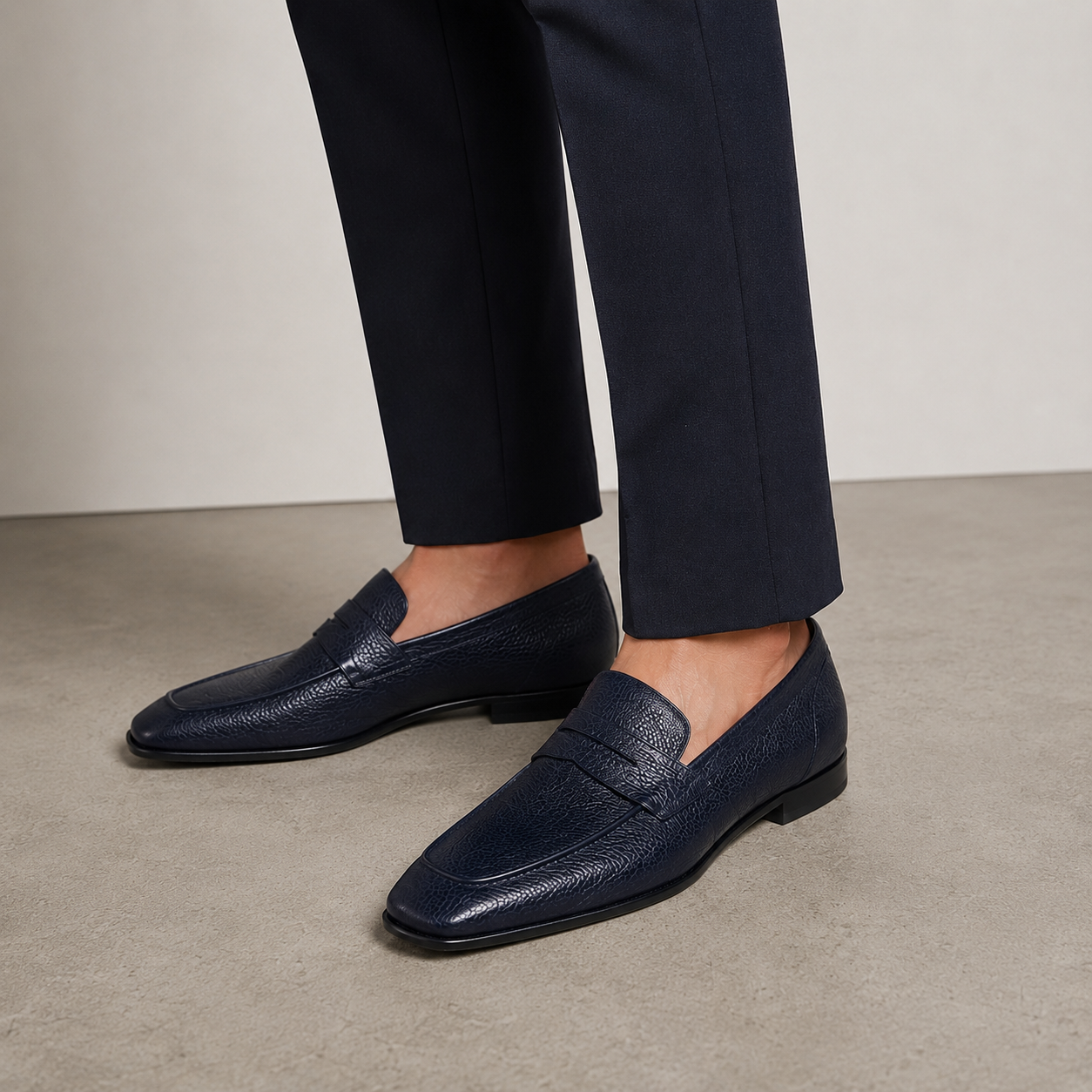 Barrett men’s navy deer leather penny loafers styled with tailored trousers.