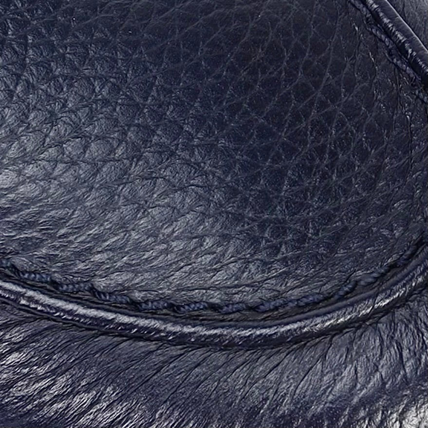     Close-up of Barrett navy grained deer leather texture and hand stitching.