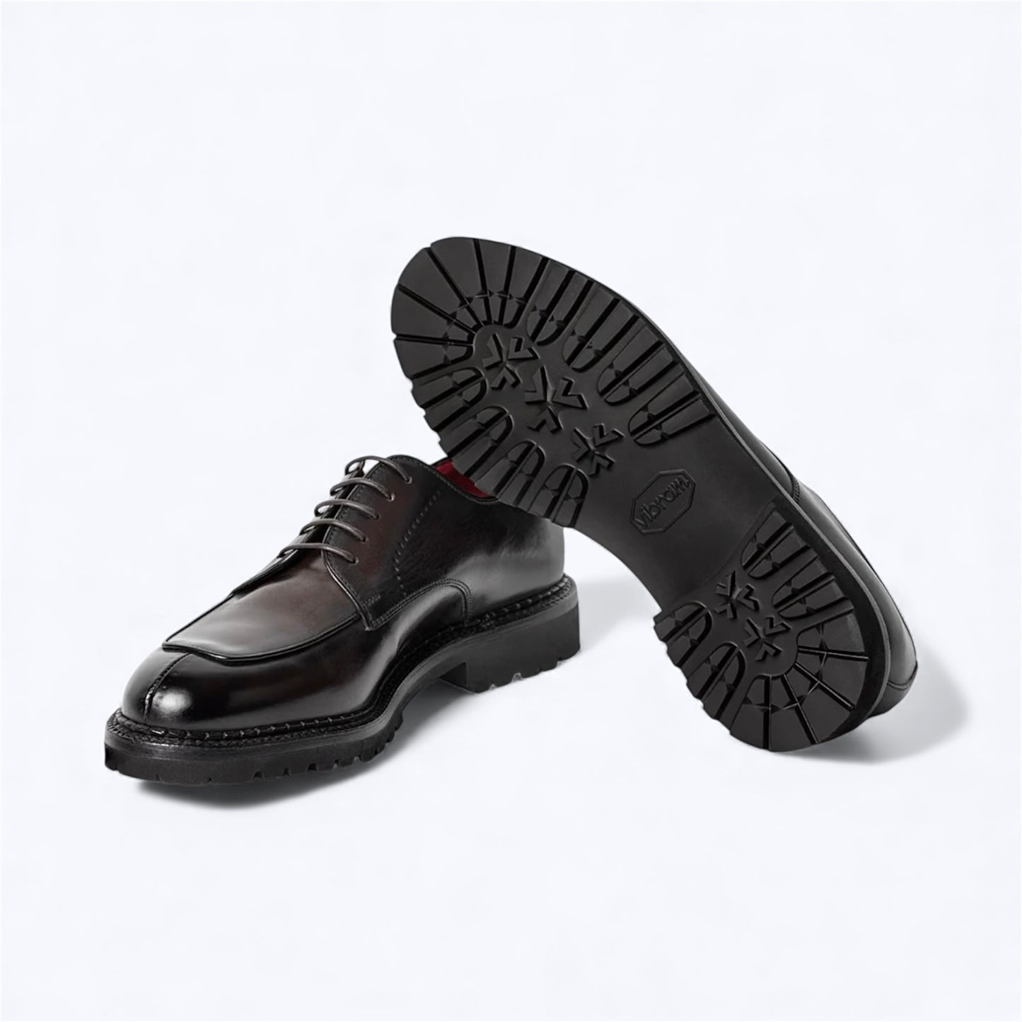 Angle view of Italian Barrett derby shoes with red leather lining.